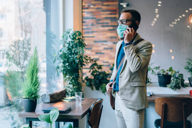 Man-with-mask-possibly-for-allergy-on-phone.